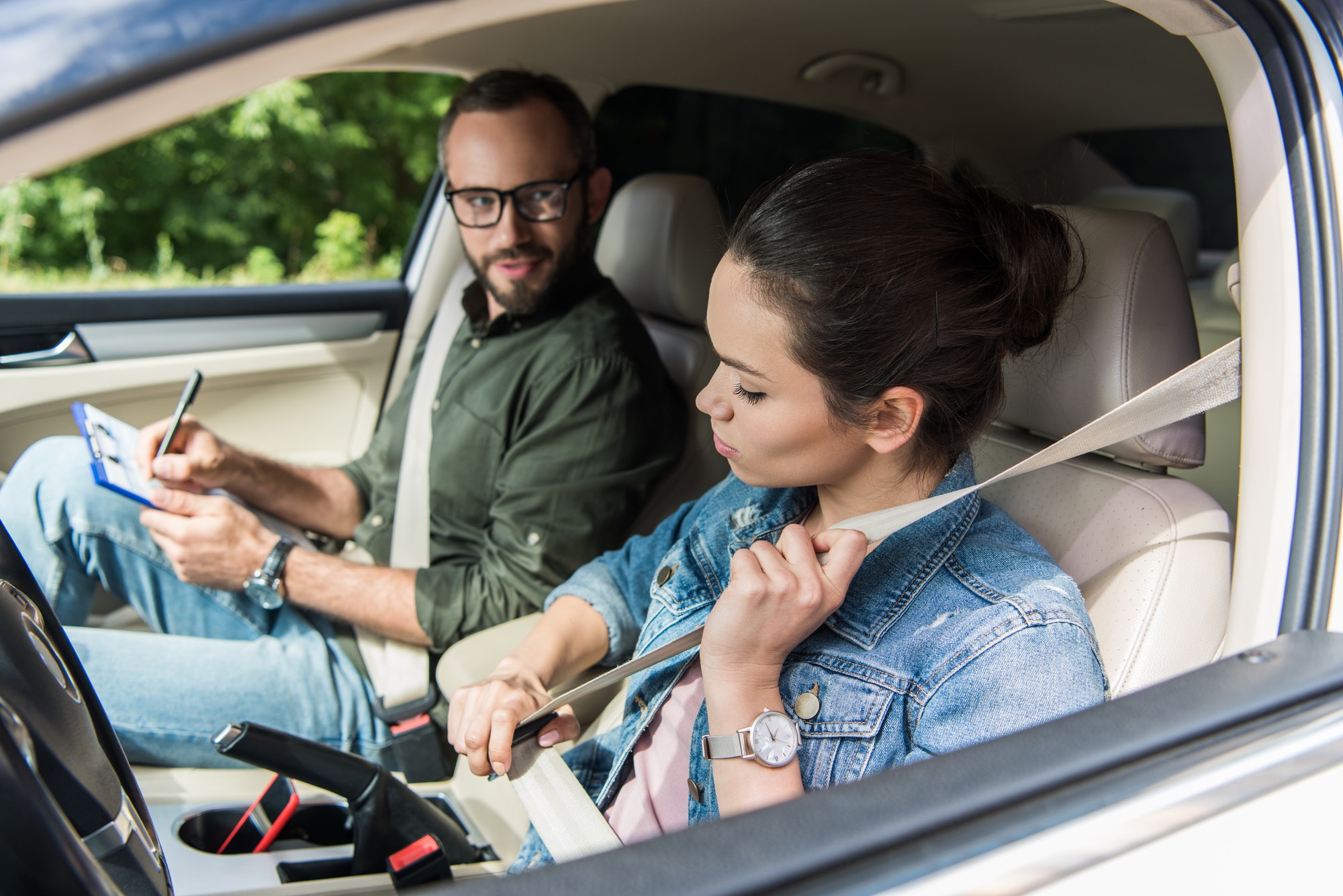 student-fastening-seat-belt-in-car-during-driving-test.jpg student-fastening-seat-belt-in-car-during-driving-test.jpg
